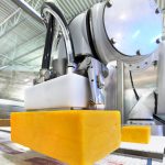 cobot moving large block of cheese